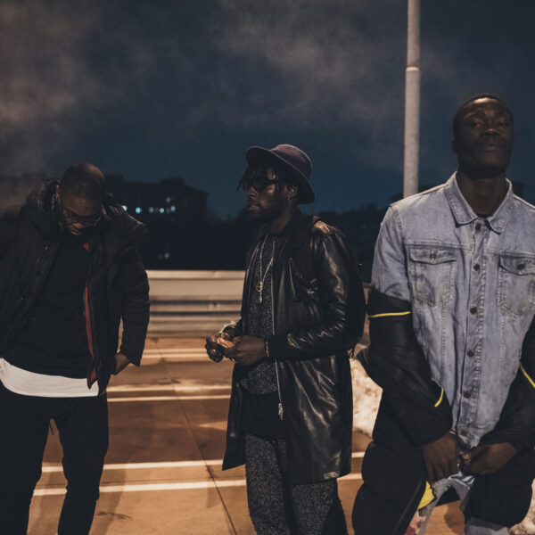 three young men posing outdoor looking camera serious - rap crew, gang, swag concept